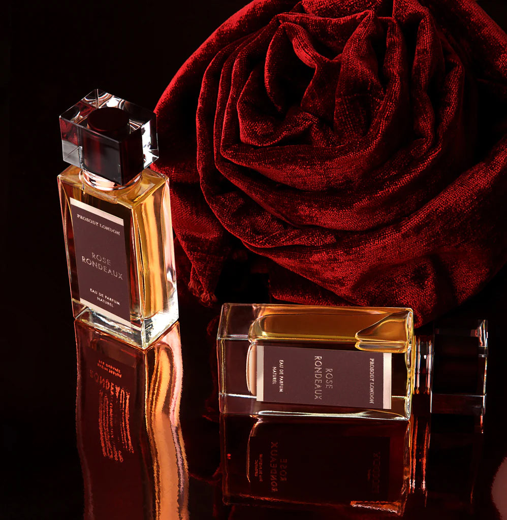 two rose perfumes with a suede curl into a rose shape