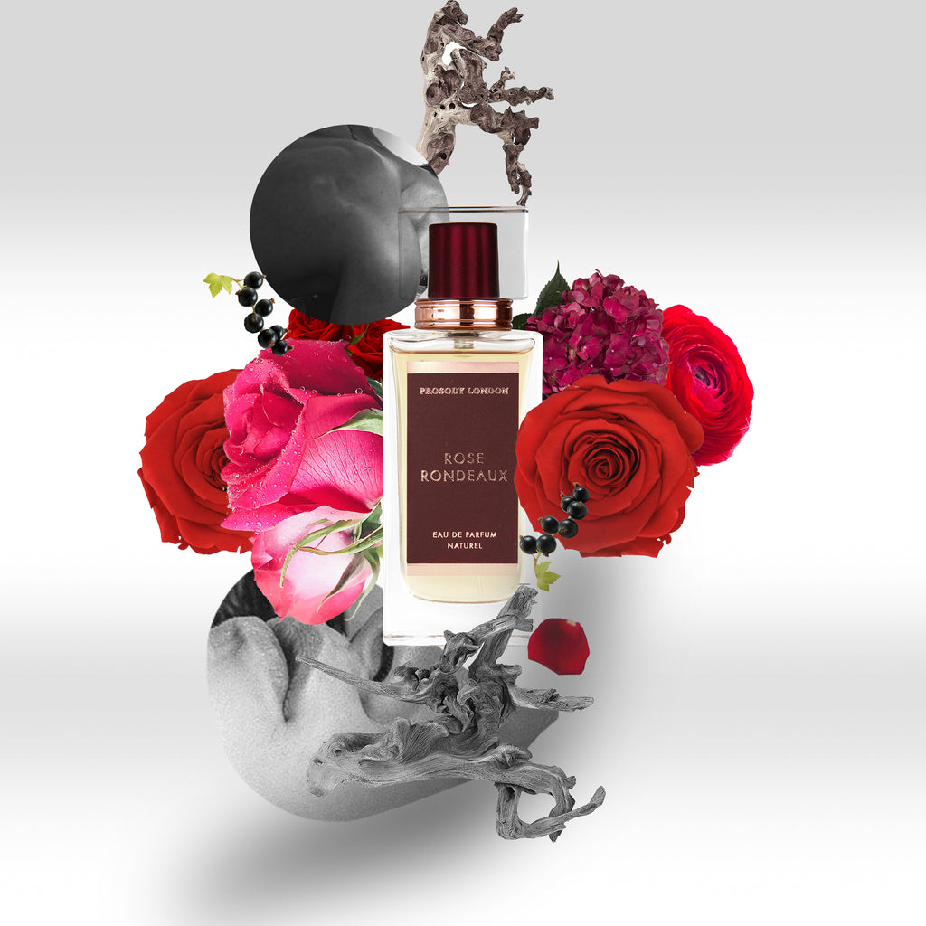 Organic and natural rose perfume with arty arrangement of roses and drift wood