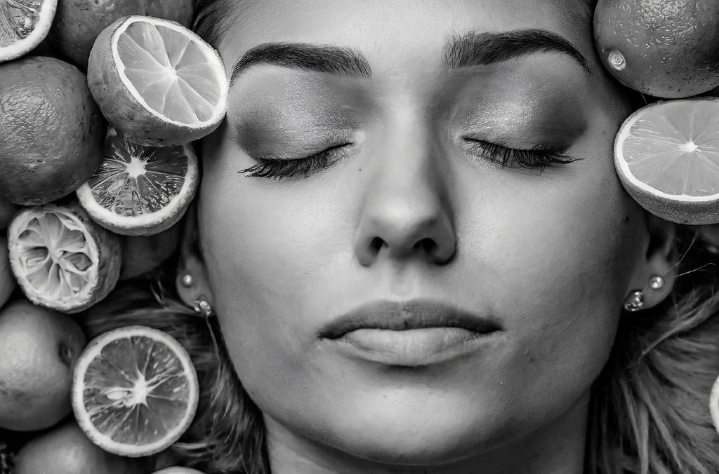 lady face surrounded by citrus fruit in black and white