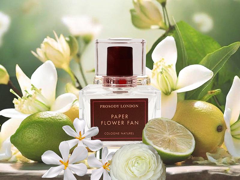 perfume bottle with white flowers and bergamot
