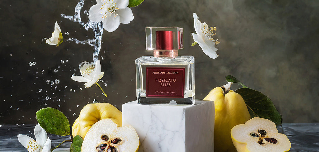 quinces and flying white florals with cologne bottle