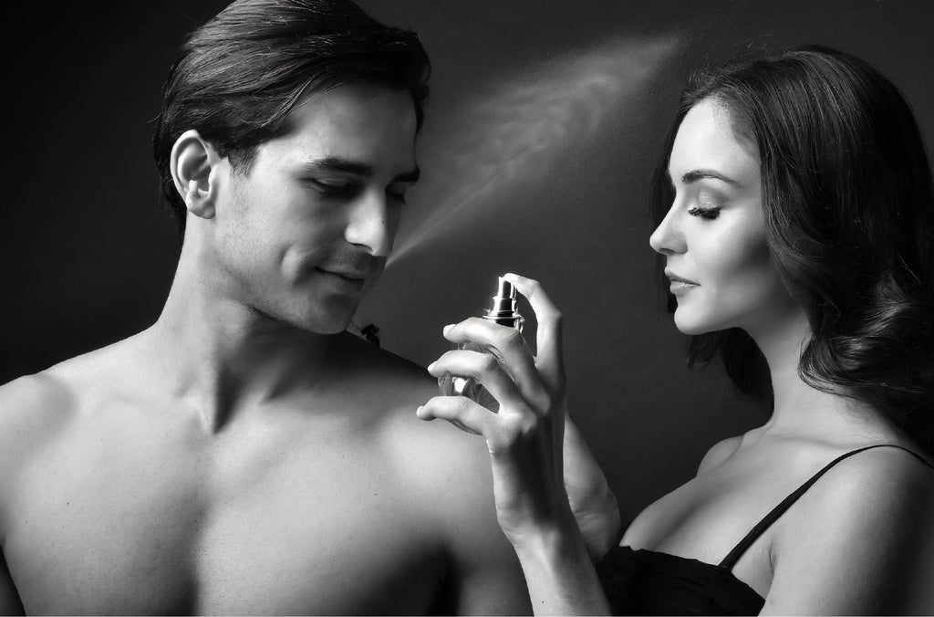 Couple spraying synthetic fragrance