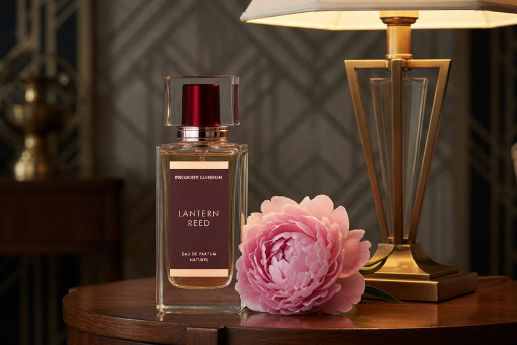 Lantern Reed natural calming perfume by Prosody London in a burgundy bottle with a pink peony
