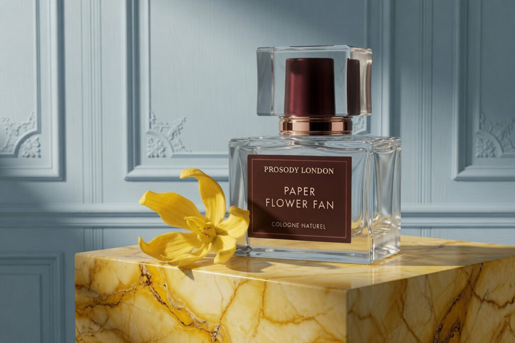 Niche Perfume by mood – Paper Flower Fan Cologne Naturel by Prosody London on a marble pedestal with a yellow ylang ylang bloom — botanical fragrance for calm and relaxation